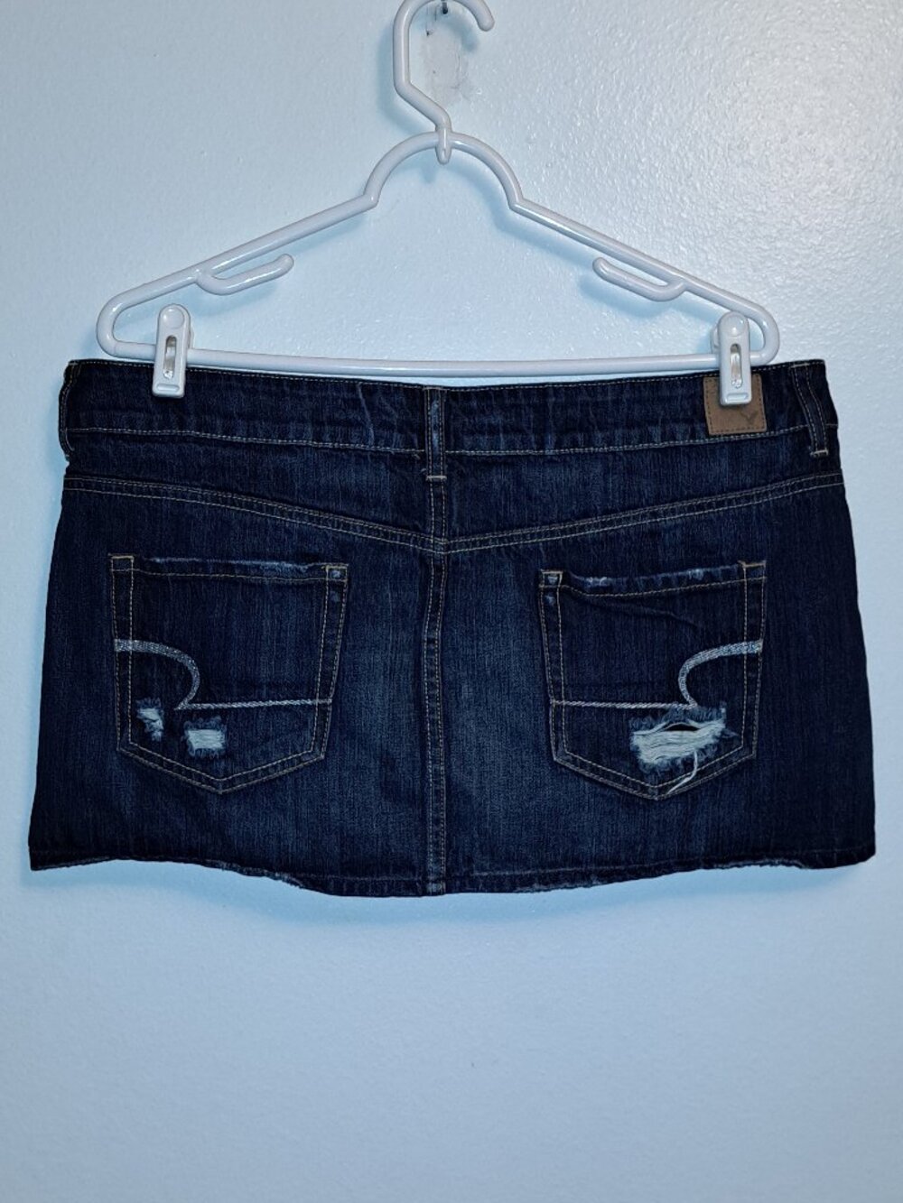 American Eagle dark wash denim mini skirt w/distressed embroidered pockets
